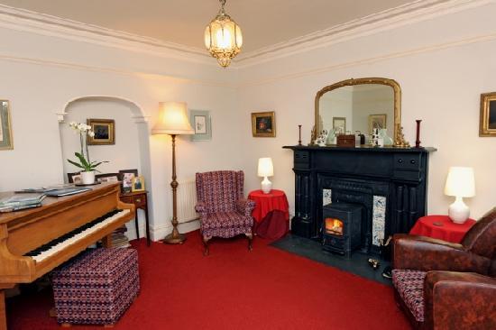 Cefn-Y-Dre Lounge with log burner and mini grand piano